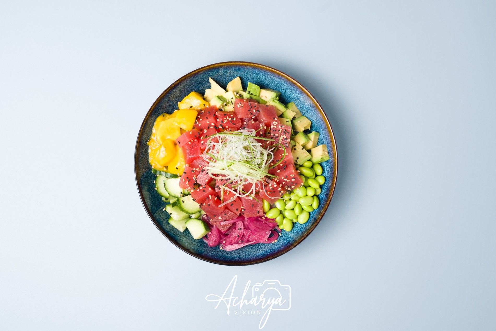 Poké bowl photographed from above on a pale background